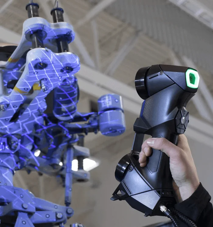 Industrial blue-light metrology scanner mid-capture.