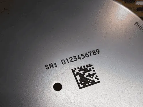High-contrast carbon laser marking on coated metal.